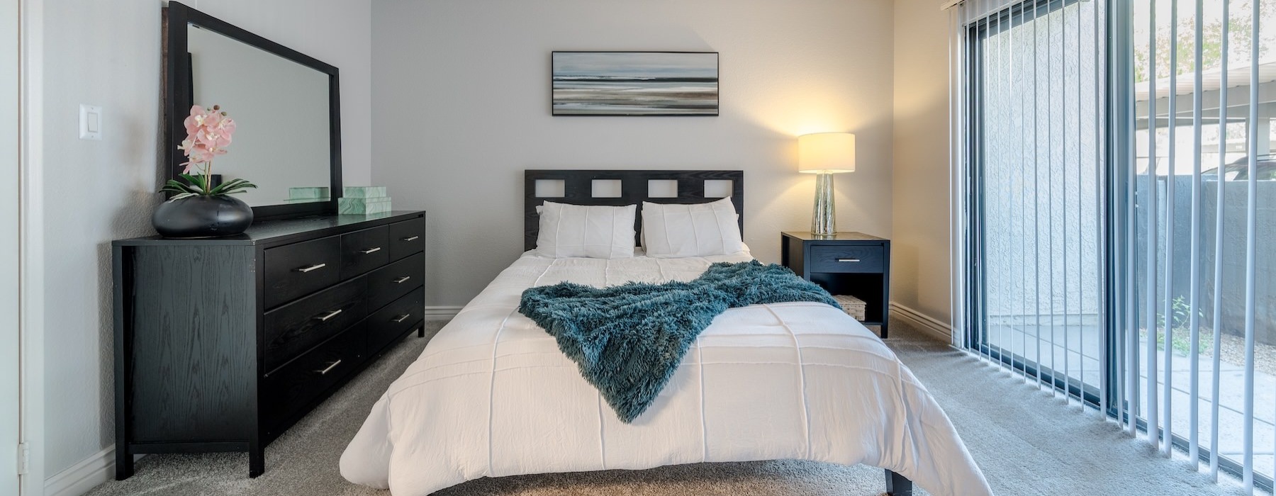 a bedroom with a bed and a lamp