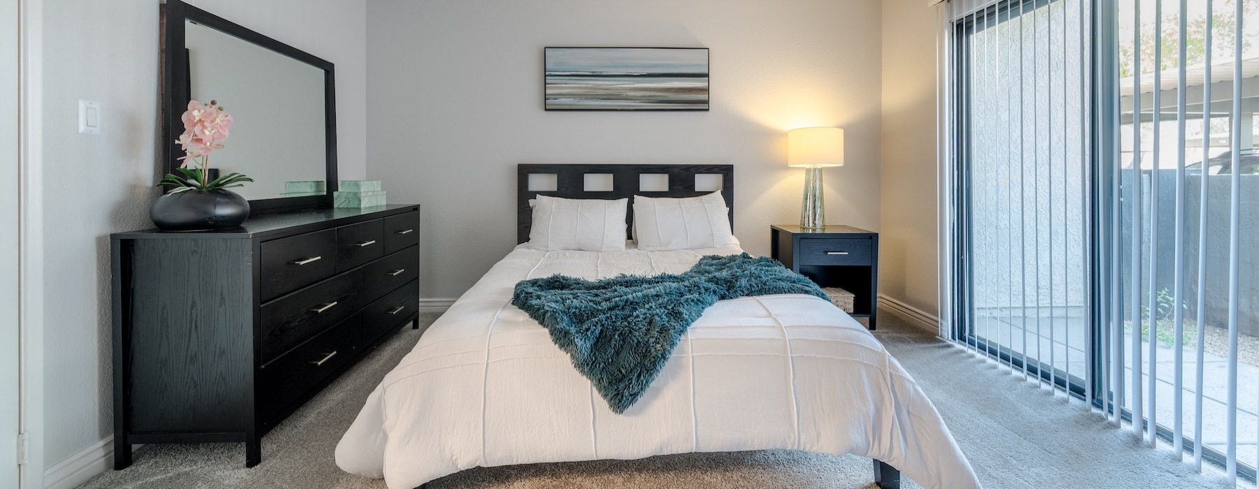a bedroom with a bed and a lamp