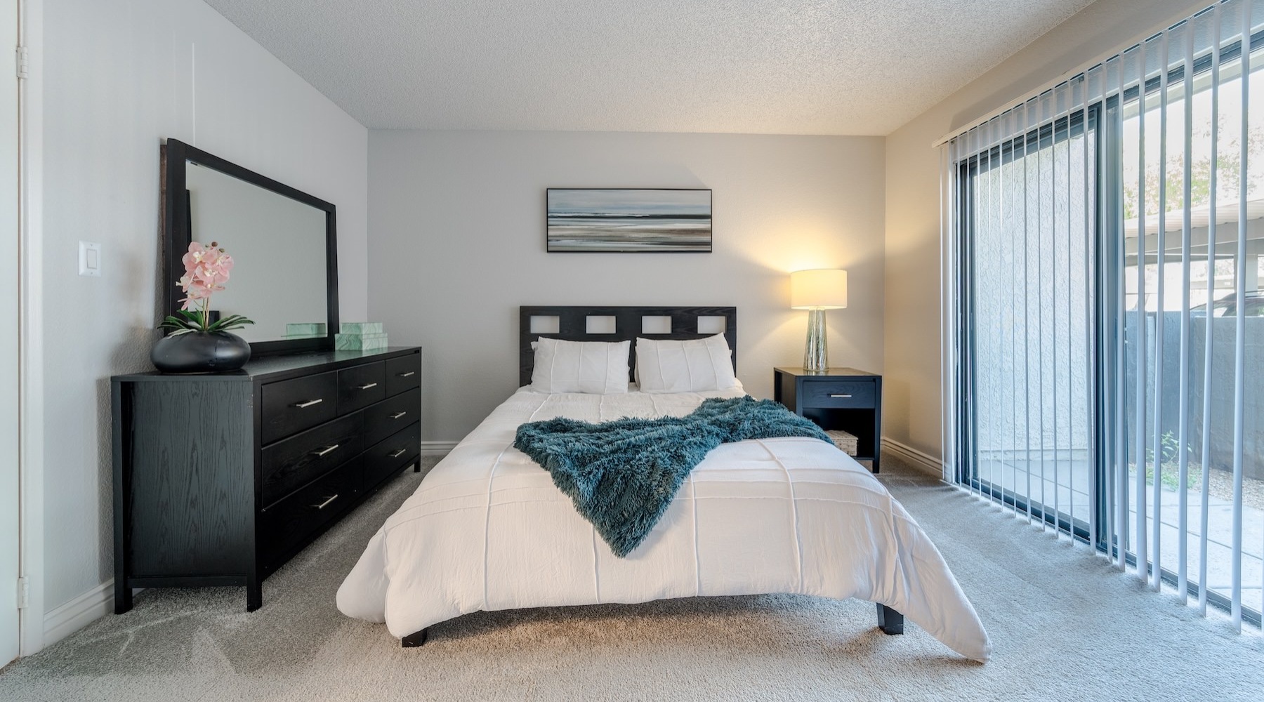 a bedroom with a bed and a lamp
