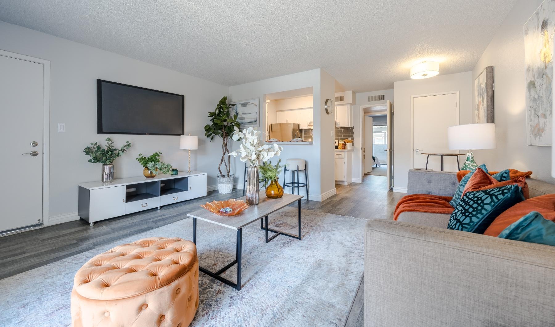 a living room with a tv and couches